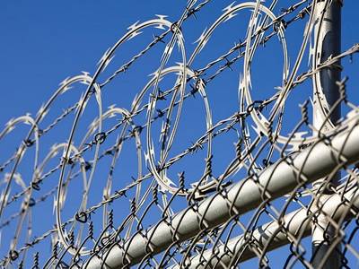 Barbed wire and razor wire are installed on the top of chain link fence