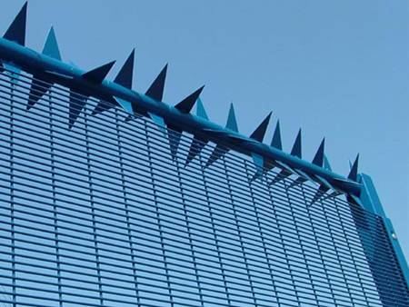 Rotary wall spikes are installed at the top of ornamental fences.
