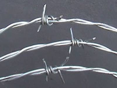 Three Double Twist Barbed Wires On grey background